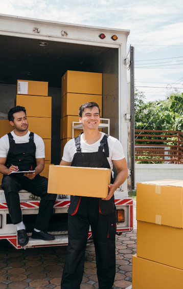 Smiling mover carrying packed box during residential move – Easy Best Moves