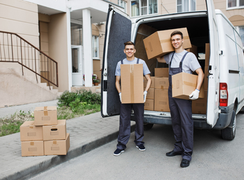 Experienced moving crew unloading boxes from truck at residence – Easy Best Moves