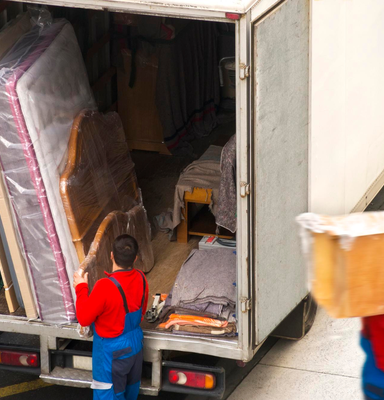 Professional movers loading wrapped furniture securely into moving truck – Easy Best Moves