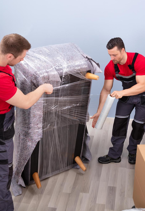 Movers wrapping and protecting furniture for safe transport – Easy Best Moves
