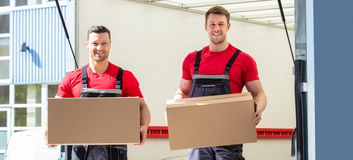 Professional movers holding packed boxes ready for transport – Easy Best Moves