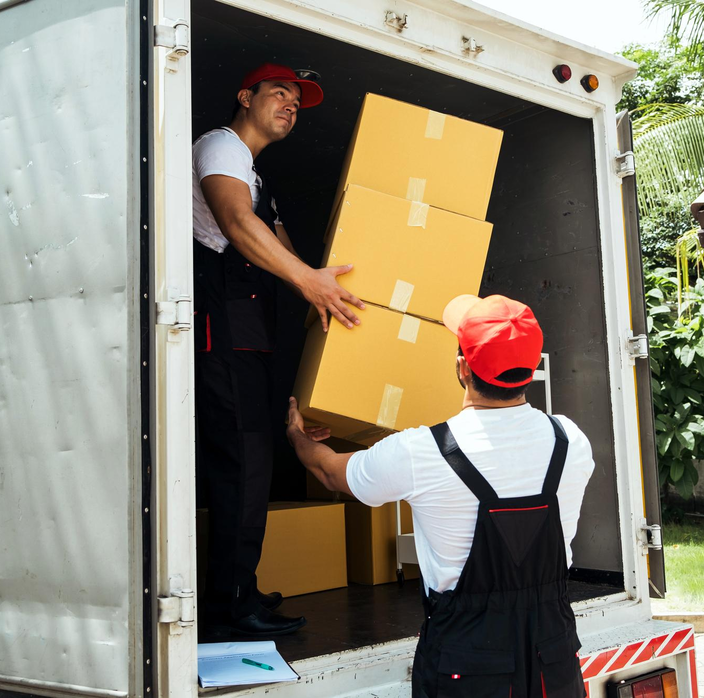 Experienced movers unloading stacked boxes safely from truck – Easy Best Moves